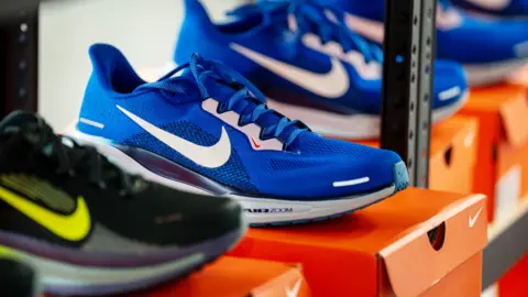 Getty Images Nike trainers in a shop displayed on top of a Nike shoe box